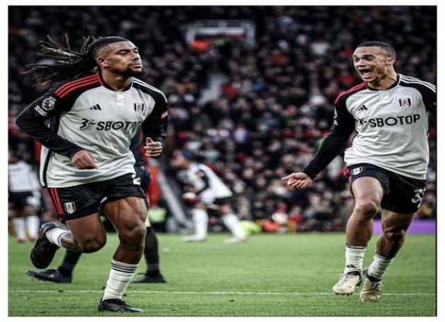 Image of Alex Iwobi, a Nigerian footballer, celebrating on a soccer field